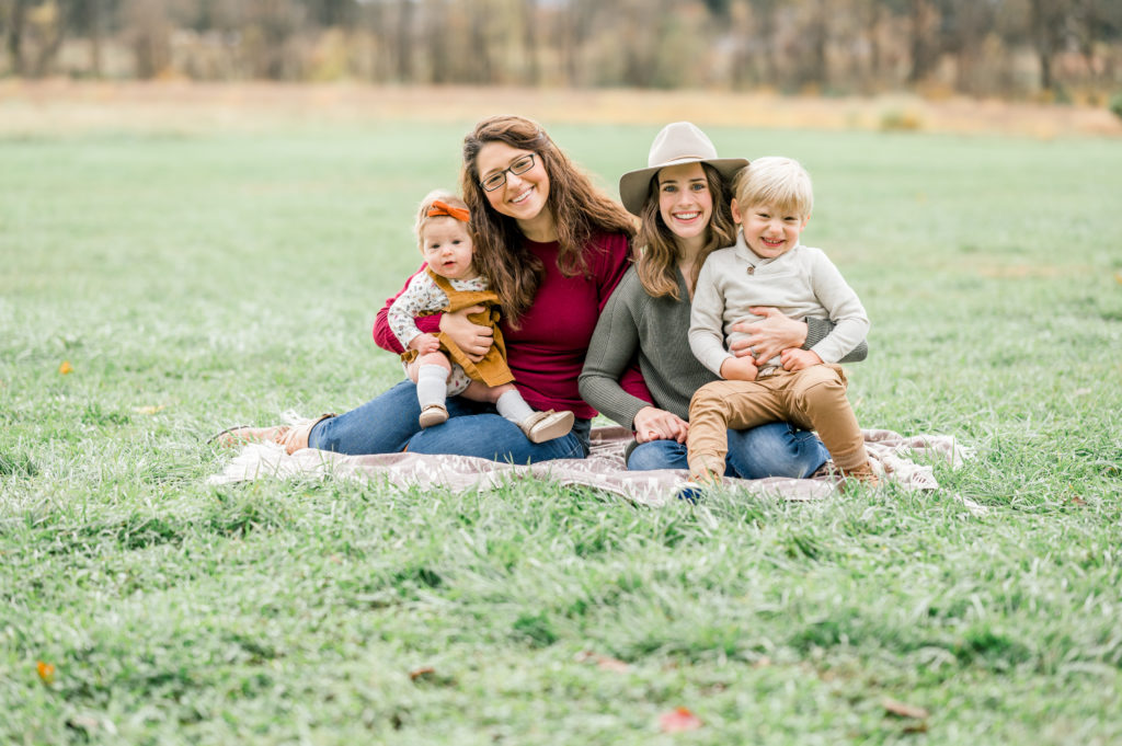 Full Jaffe family taking a family portraits in the grass 