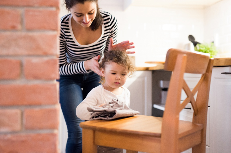 a mom putting up her daughters hair